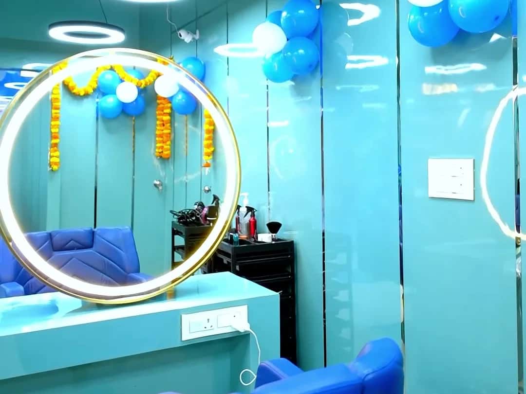 Gold ring mirror and royal blue styling chairs at Scissors Professionals Kolapakkam