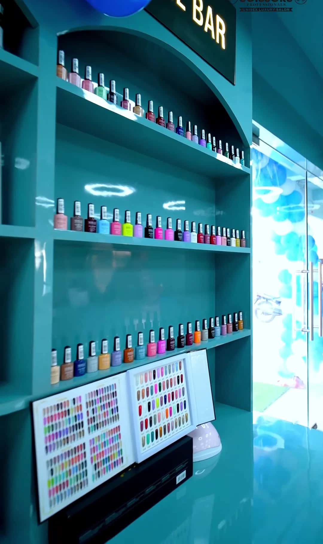 Rows of nail polish colours and a nail colour chart at the Nail Bar counter