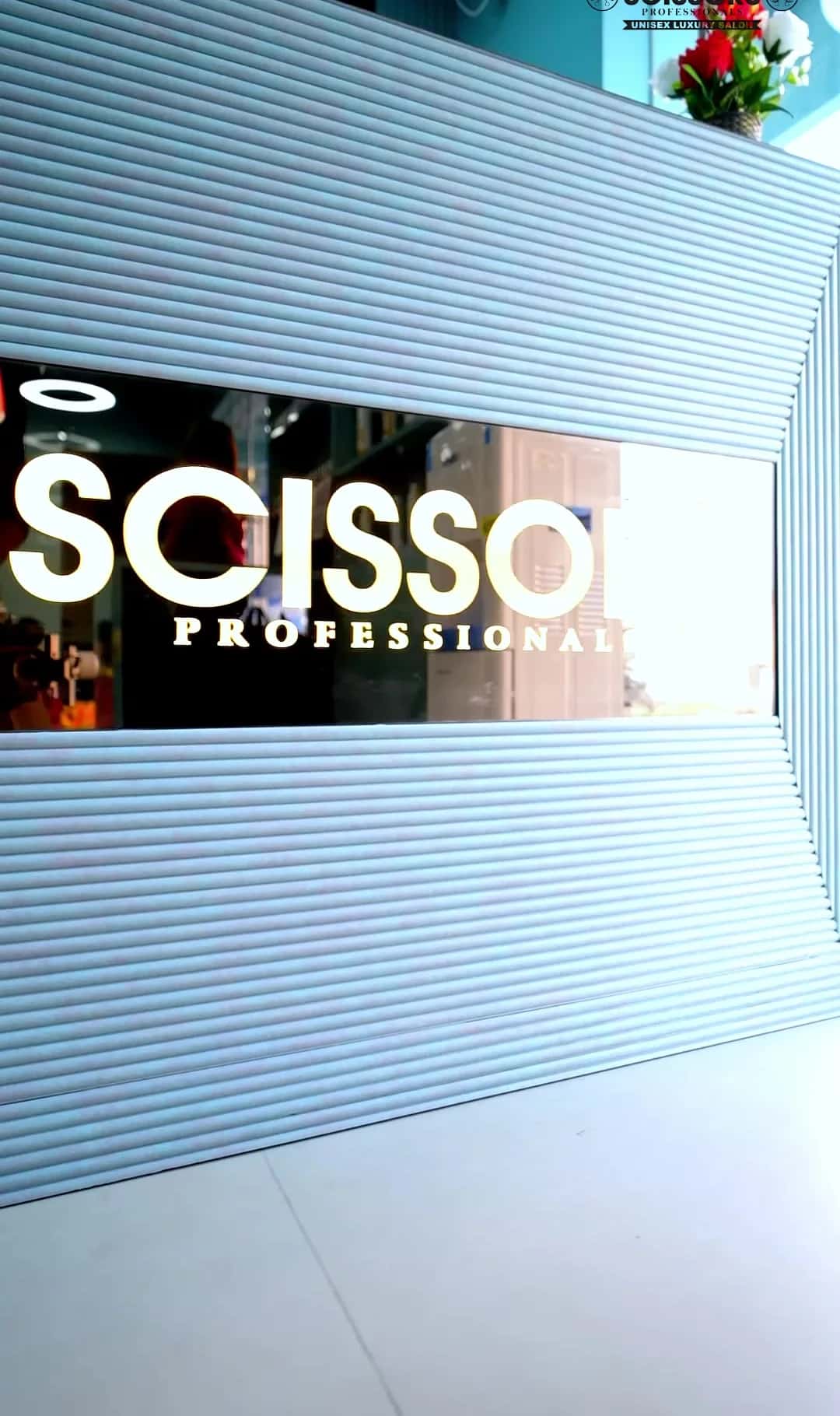 Close view of the Scissors Professionals name on the fluted reception desk