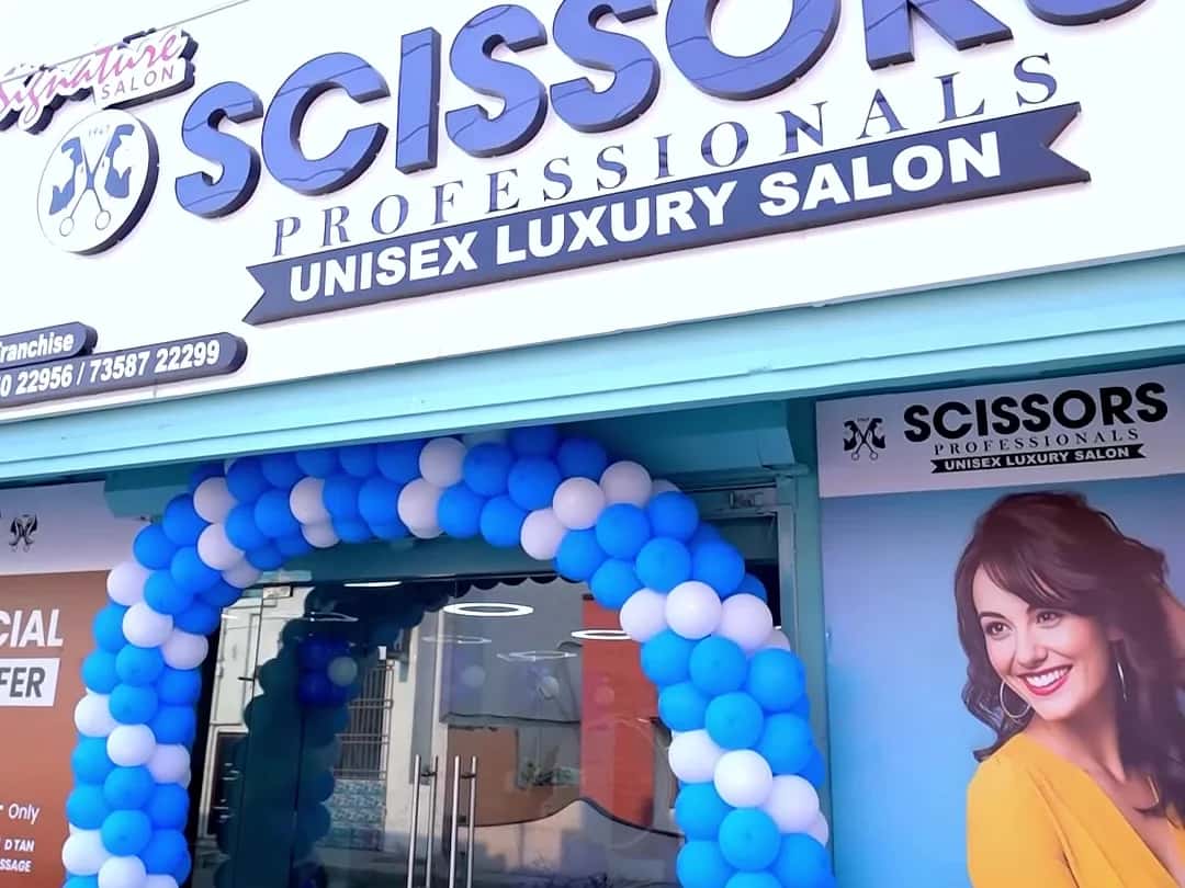 Scissors Professionals Unisex Luxury Salon storefront with a blue and white balloon arch at the entrance, Kolapakkam