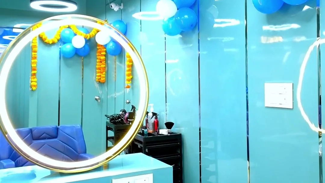 Gold ring mirror and royal blue styling chairs at Scissors Professionals Kolapakkam